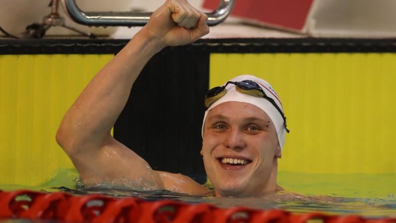 Great Britain's Aaron Moores celebrates breaking the world record in the men's 100m breaststroke final at the 2016 British Para-Swimming International Meet.