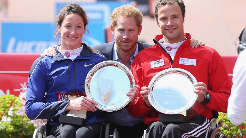Prince Harry poses with the USA's Tatanya Mcfadden and Switzerland's Marcel Hug after both won the 2016 Virgin Money London Marathon.
