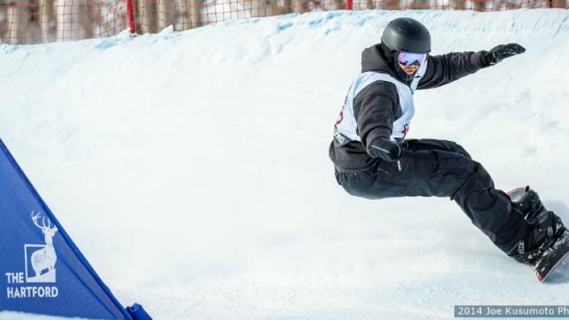 Male snowboarder going down a slope