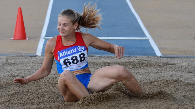 Woman lands in the sand pit 