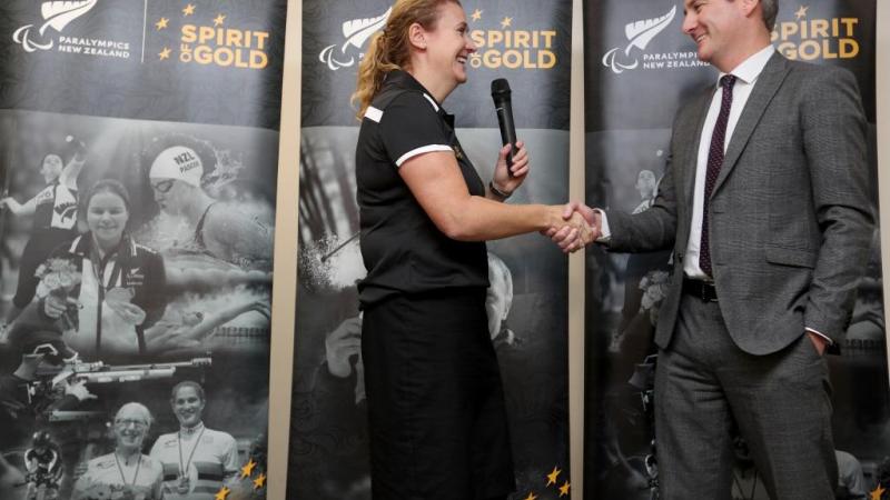 Paralympics NZ CEO Fiona Allan shakes hands with sponsor Marty Kerr from VISA