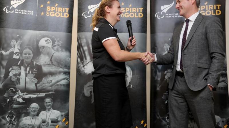Paralympics NZ CEO Fiona Allan shakes hands with sponsor Marty Kerr from VISA