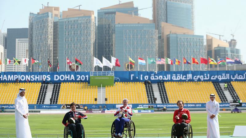 Podium with three women in wheelchairs