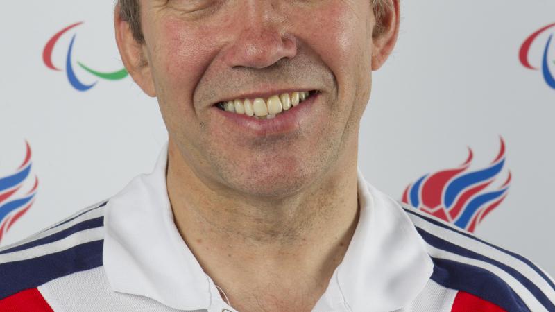 Nick Webborn wears the ParalympicsGB uniform whilst he smiles to the camera.