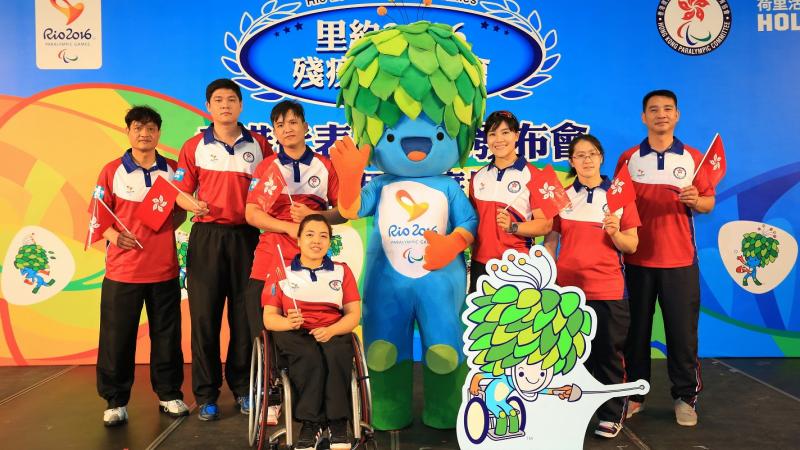 Seven athletes posing with Rio 2016 Tom mascot