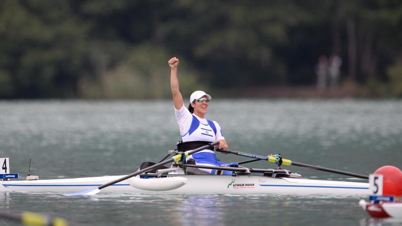 Woman in roing boat celebrates