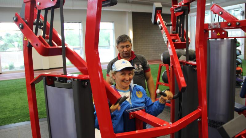 Woman in wheelchair tries out arm exercise machine