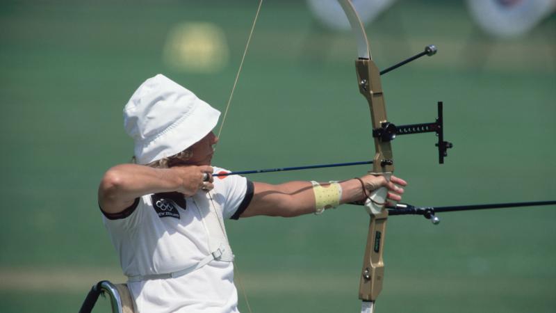 Woman in wheelchair doing archery