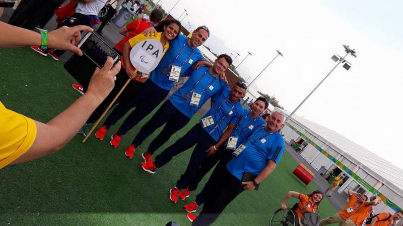 A group of people pose at the Rio 2016 Athlete Village