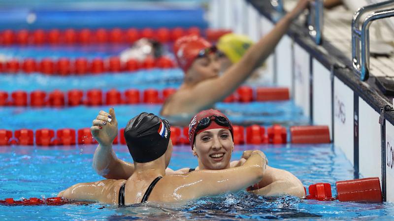 Bethany Firth (R) of Great Britain is embraced by Marlou van der Kulk (L) of the Netherlands after winning the gold medal in the Women's 100m Backstroke