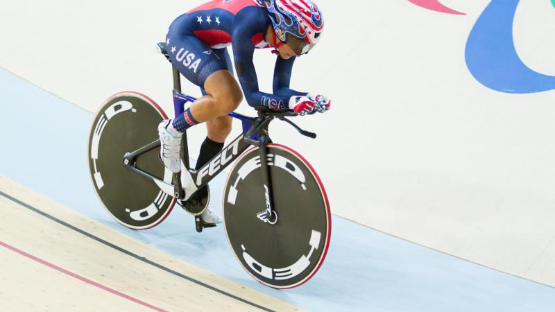 Woman on bike in a velodrome