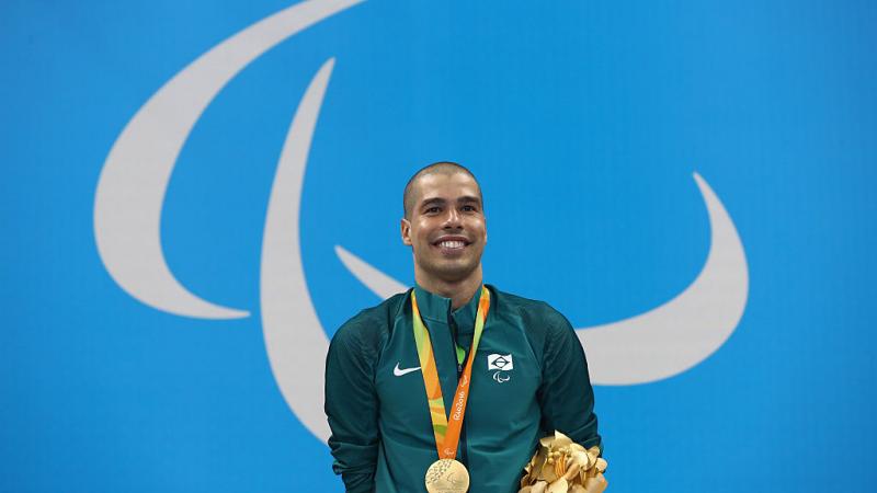 Gold medalist Daniel Dias of Brazil celebrates on the podium at the medal ceremony for the Men's 200m Freestyle - S5 Final on day 1 of the Rio 2016 Paralympic Games