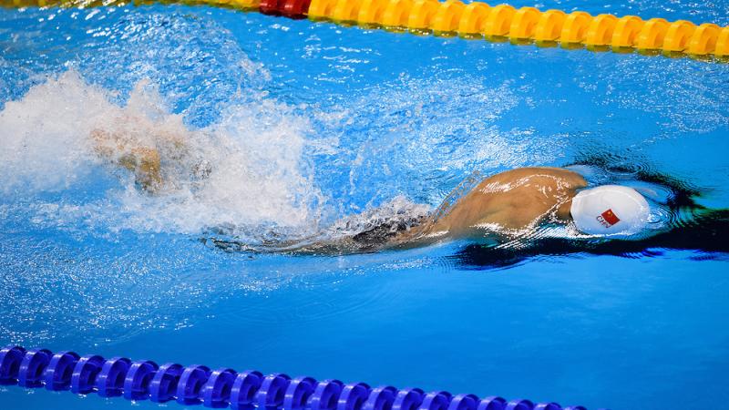 Lichao Wang CHN competes in Heat 2 of the Men's 50m Butterfly S6 at the Olympic Aquatics Stadium.