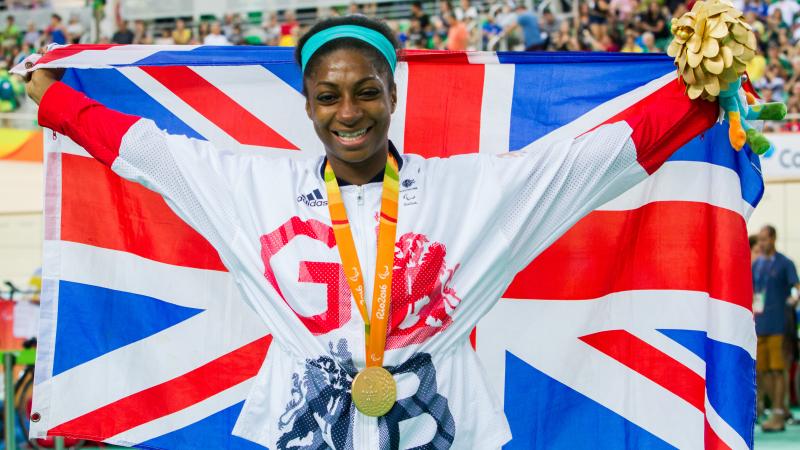 Woman with British flag and medal around her neck