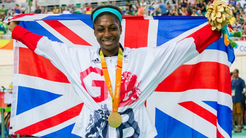 Woman with British flag and medal around her neck