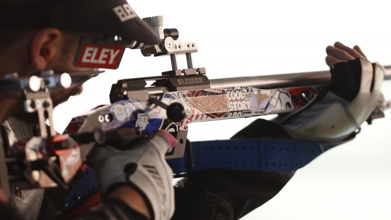 A shooting para athlete holding a rifle.