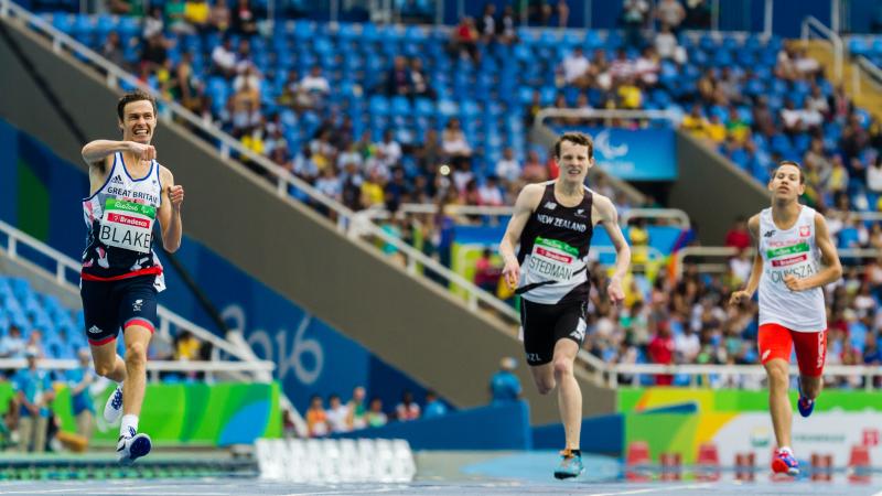 three runners sprint for the line