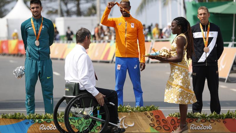 three men on a podium