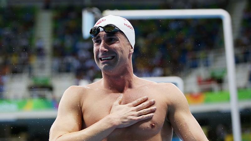 A swimmer is delighted with his victory.