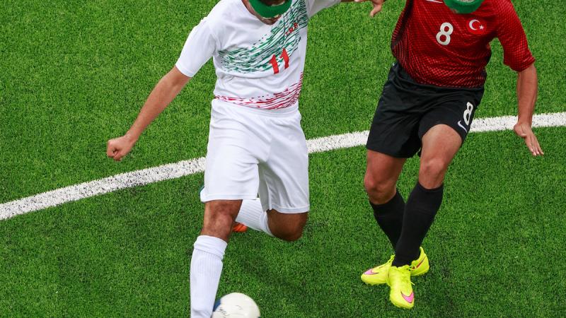 Two blind footballers fighting for the ball