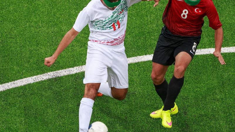 Two blind footballers fighting for the ball