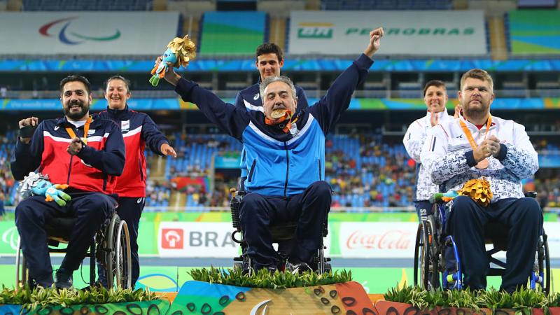 Gold medalist Zeljko Dimitrijevic of Serbia  poses on the podium at the medal ceremony for Men's Club Throw - F51