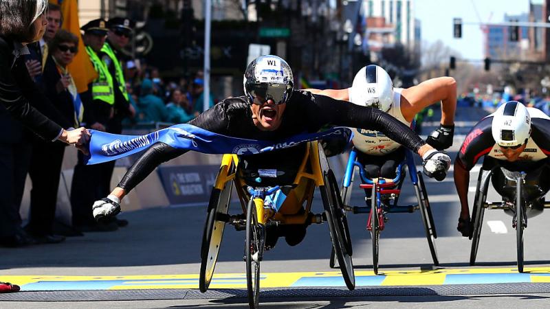 Marcel Hug of Switzerland crosses the finish line to win the men's push rim wheelchair race during the 120th Boston Marathon on April 18, 2016 in Boston.