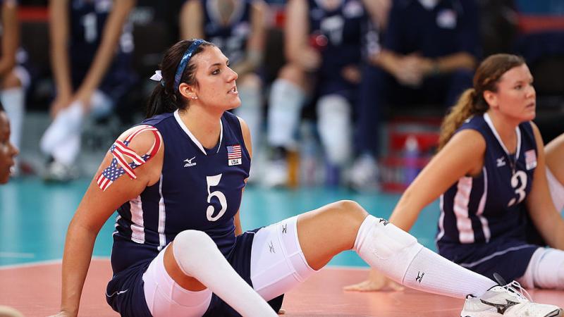 Woman sitting on a volleyball court