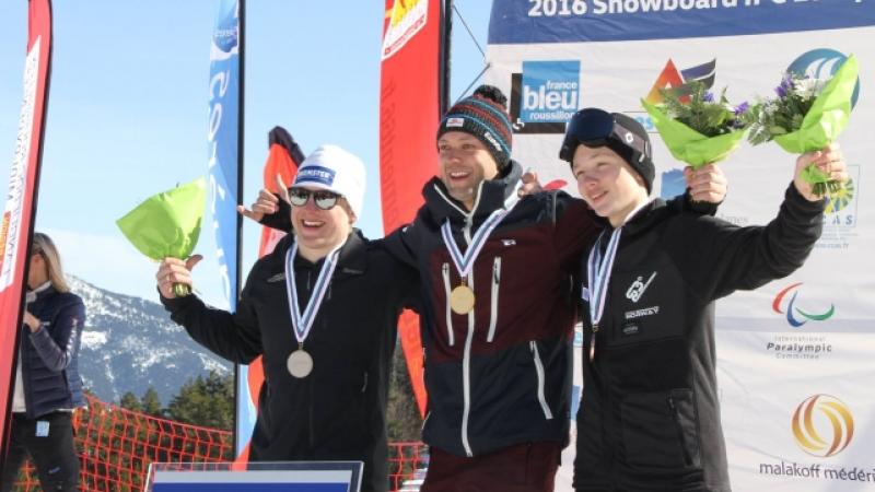 Three men on a podium