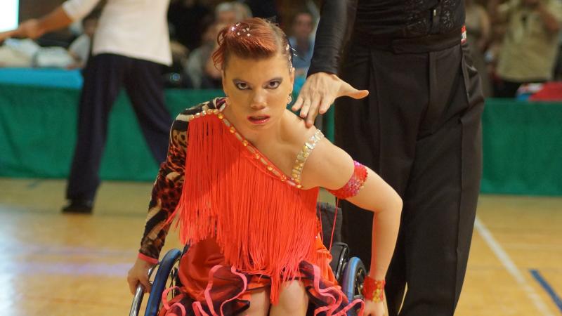 A woman in a wheelchair dances with a standing partner