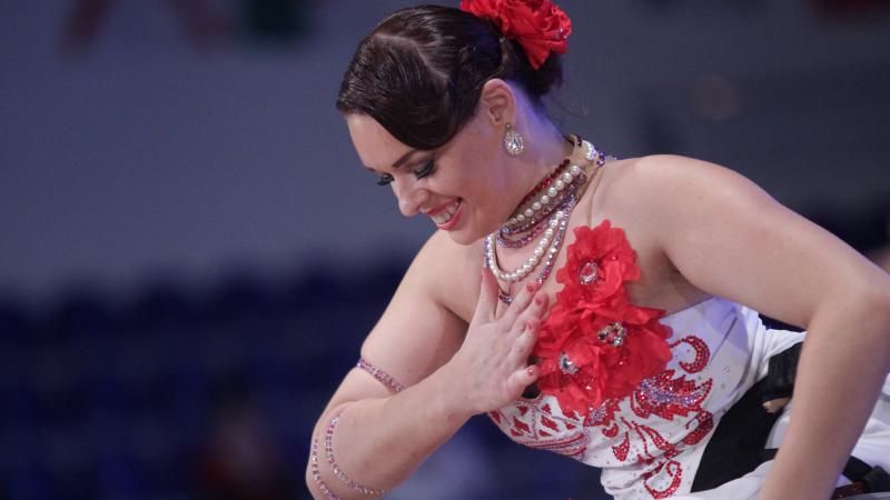 Woman wheelchair dancer bows to the audience