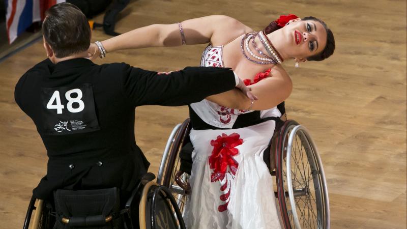 A man and woman in wheelchairs dancing