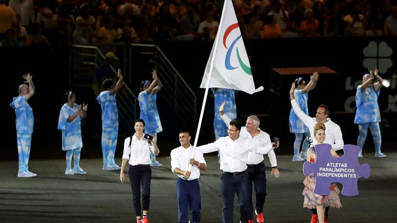 Flag bearer Ibrahim Al Hussein of Syria leads the Independent Paralympic Athletes team entering the stadium during the Opening Ceremony of the Rio 2016 Paralympic Games.