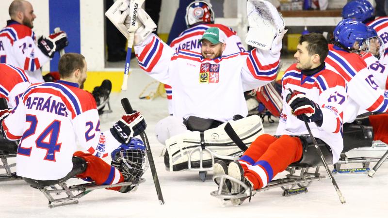 Para ice hockey players celebrate their gold medal win