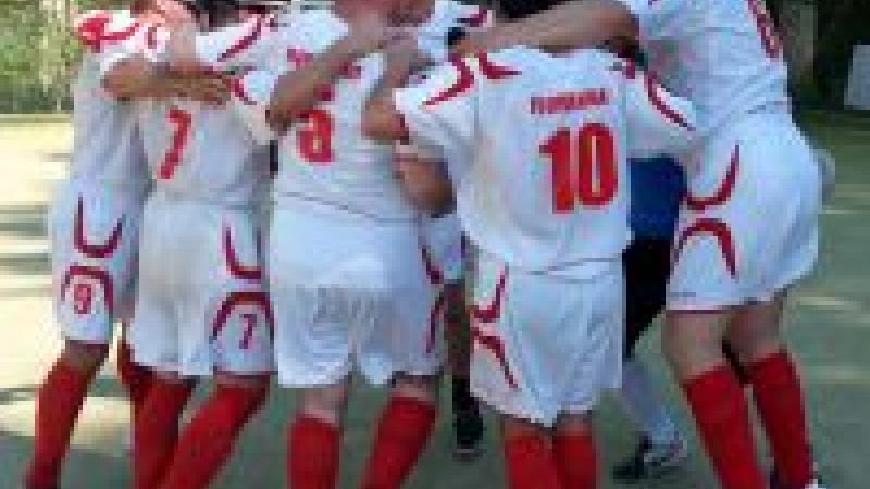 Blindfolded men in jerseys celebrating