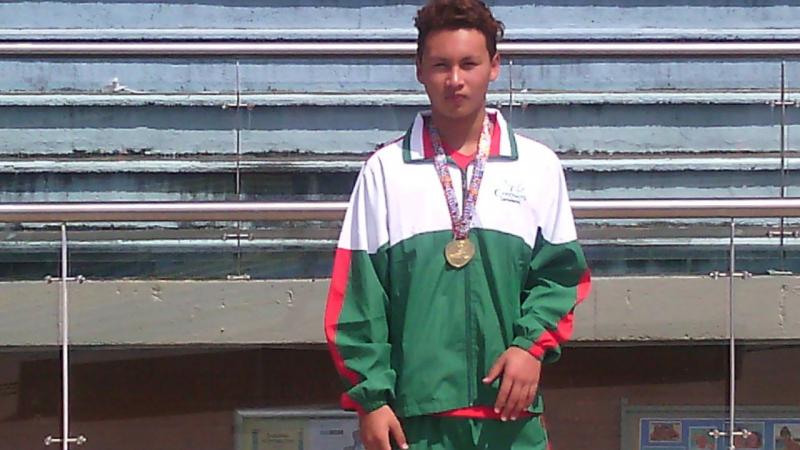 A swimmer poses with a medal