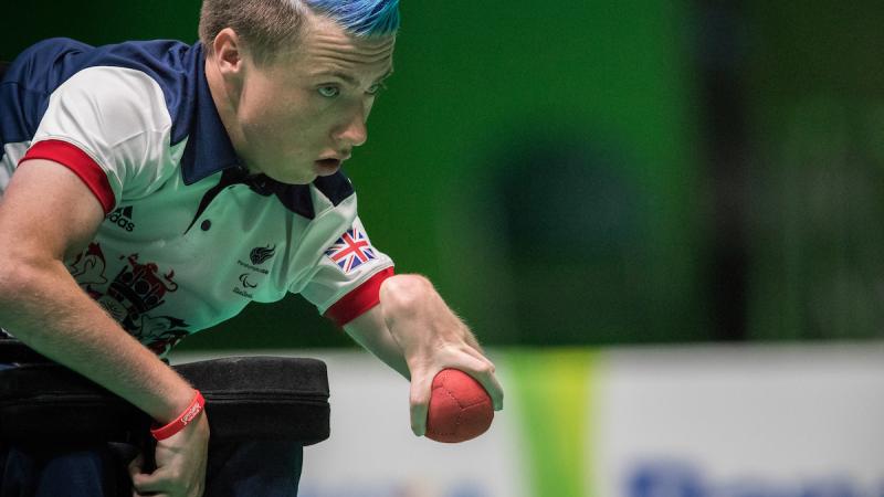 a male boccia player prepares to throw the ball