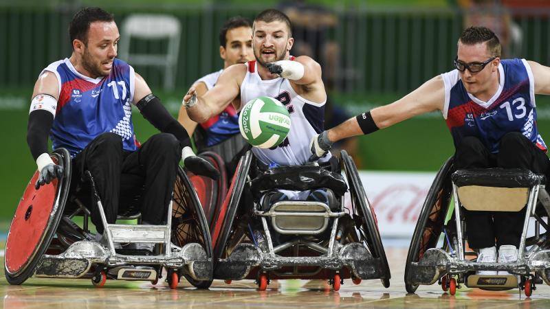 Kory Puderbaugh of United States and Christophe Salegui and Jonathan Hivernat of France compete during the Wheelchair Rugby match between United States and France