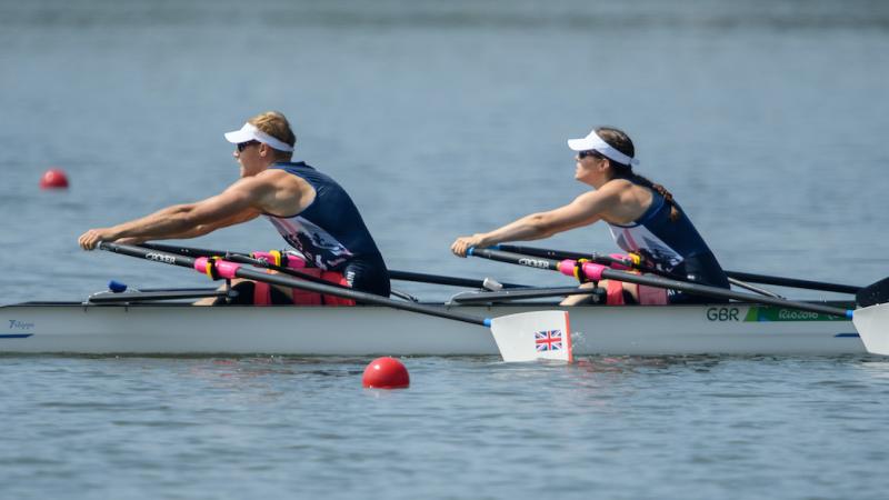 Two rowers in a boat on the water