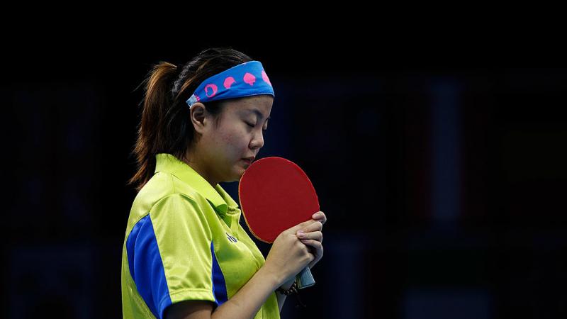 Chinese table tennis player kissing her racket.