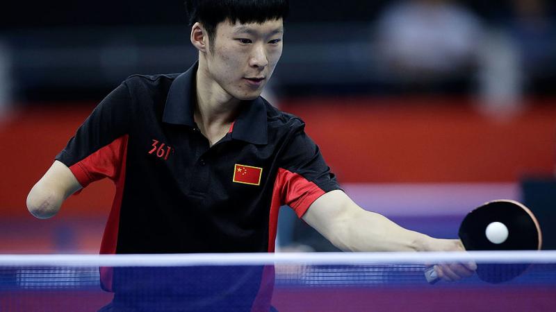 Yang Ge of China returns serve against Sebastian Powrozniak of Poland during the final of the Men's Team Table Tennis - Class 9-10 London 2012