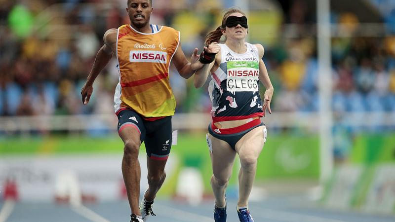 Chris Clarke and Libby Clegg of Great Britain in action during the women's 100m - T11 Semifinals at the Olympic Stadium on Day 2 of the Rio 2016 Paralympic Games