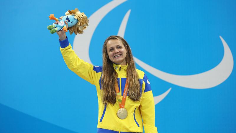 Gold medalist Anna Stetsenko of Ukraine celebrates on the podium at the medal ceremony for the Women's 100m Backstroke - S13 on day 10 of the Rio 2016 Paralympic Games