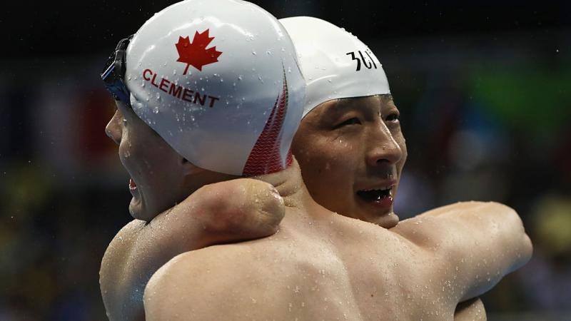 Qing Xu - Rio 2016 Xu Qing (R) of China is embraced by Nathan Clement (L) of Canada after winning the gold medal in the Men's 50m Butterfly - S6