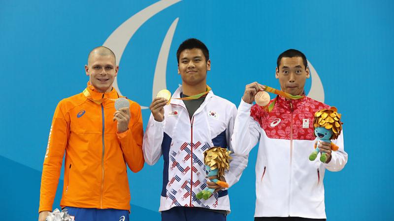Gold medalist Lee In Kook of South Korea and Bronze medalist Takuya Tsugawa of Japan pose on the podium at the medal ceremony for the Men's 100m Backstroke - S14 Final on day 1 of the Rio 2016 Paralympic Games 