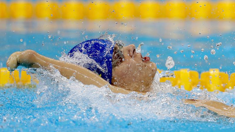 Ievgenii Bogodaiko - Rio 2016 Close up of a swimmer with an impaired arm doing backstroke.
