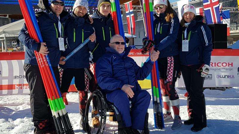 Group picture with skiers and man in wheelchair