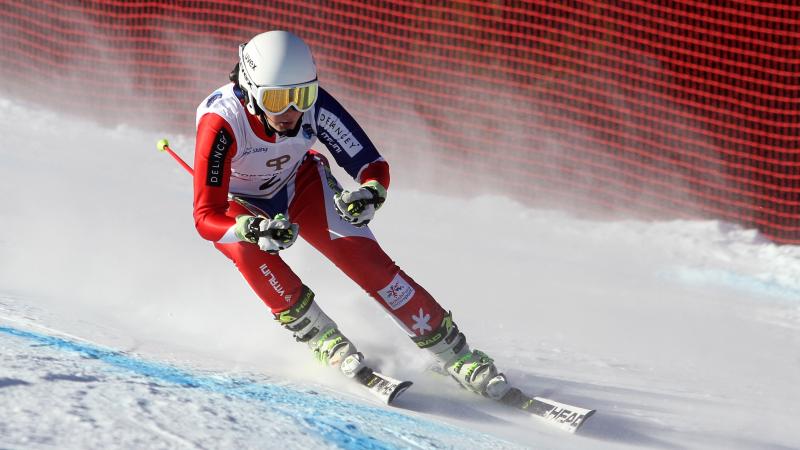 a female Para skier heads down slope