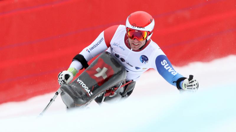 Man in sit ski in action on the slopes