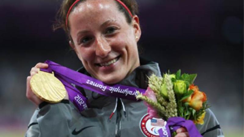 A picture of a woman showing her gold medal